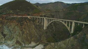 Bixby Bridge. Pacific Coast Highway and Ocean. Monterey, Big Sur, California, USA. Aerial View. Drone Flies Backwards video