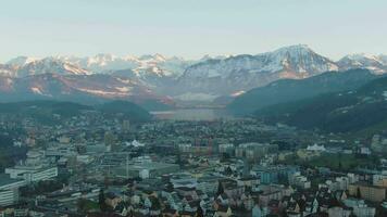 Kriens Cityscape and Mountains in Winter Evening. Swiss Alps, Switzerland. Aerial View video