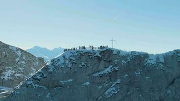 Tourists on Observation Deck of Mount Pilatus Top in Winter Sunny Morning. Blue Mountains. Swiss Alps, Switzerland. Aerial View. Drone Flies Upwards, Tilt Down video