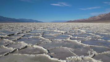 Badwater Basin at Sunny Day. Salt Crust Formations and Blue Sky. Death Valley National Park. California, USA. Tilt Up video