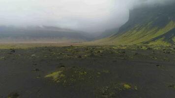 vert montagnes, noir le sable et mousse, gris ciel. paysage de Islande. aérien voir. révéler coup video