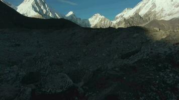 Pumori, Lingtren, Khumbutse and Nuptse Mountains at Sunny Day. Himalaya, Nepal. Aerial View. Drone Flies Forward, Tilt Up. Reveal Shot video