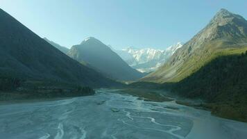 Icy Akkem Lake and Snow-Capped Altai Mountains in Sunny Day. Siberia, Russia. Aerial View. Drone Flies Sideways video