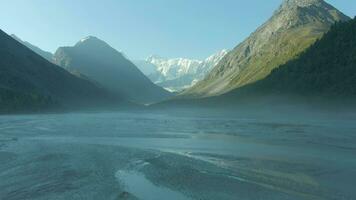 Akkem Lake and Snowy Altai Mountains in Sunny Day. Siberia, Russia. Aerial View. Drone Flies Backwards video