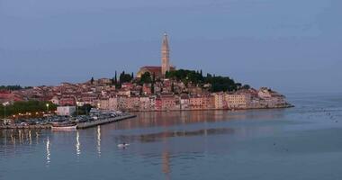 Drone video of the historic Croatian coastal town of Rovinj during sunrise