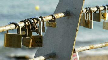 Padlocks with Names of Couples in Love at Sunset with Sea in the Background video