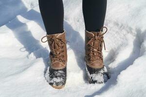 boots of a woman Standing in the Snow photo