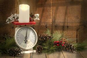 Christmas Display with Greens and Antique Scalle on Barnwood Background photo