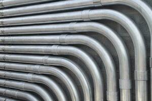 Steel Conduit Lines Run Along a Block Wall photo