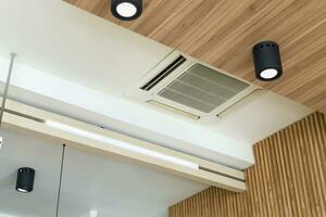 Modern ceiling mounted cassette type air conditioning system in coffee shop photo