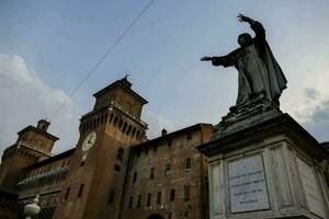 a statue in front of a large building photo