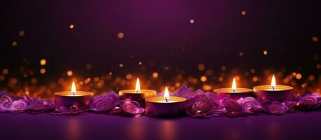 Glowing candles for Indian holiday Diwali Festival of lights on purple background photo