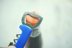 Metal cap and opener on the glass bottle photo