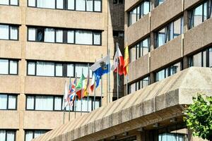 a building with many flags on the outside photo