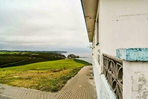 a view of the ocean from a house on the side of a hill photo