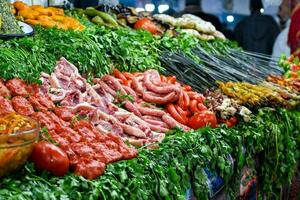 a market with many different types of meat and vegetables photo