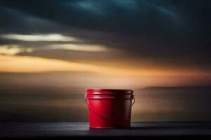 a red bucket sitting on a table in front of a sunset. AI-Generated photo