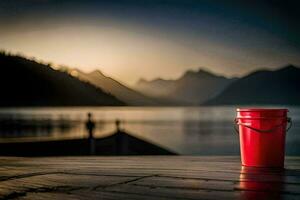 un rojo Cubeta sentado en un de madera cubierta con vista a un lago. generado por ai foto