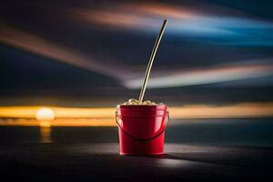 a red bucket with a straw sitting on the beach. AI-Generated photo