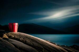 a red bucket sits on top of a rock overlooking the ocean. AI-Generated photo