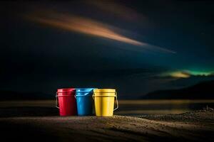 three colorful buckets sit on the sand at night. AI-Generated photo