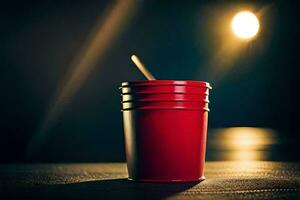 un rojo taza con un de madera palo sentado en un mesa. generado por ai foto