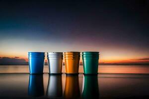 four colorful cups sit on the shore at sunset. AI-Generated photo