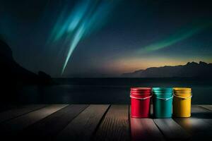 three colorful cans sit on a wooden deck overlooking the ocean. AI-Generated photo