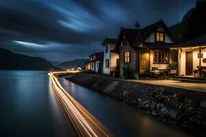 a house on the water at night. AI-Generated photo