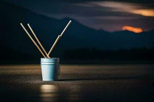 a cup with two sticks in it sitting on the ground. AI-Generated photo