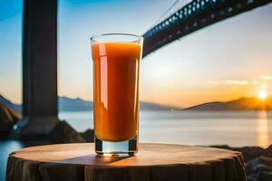 a glass of orange juice on a table in front of a bridge. AI-Generated photo