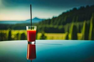 un vaso de rojo jugo sentado en un mesa en frente de un montaña. generado por ai foto