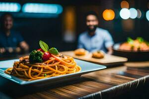 a plate of spaghetti on a table with two men in the background. AI-Generated photo