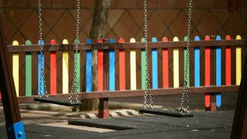 Empty swings in a playground video