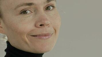 a close up of a woman with black turtle neck shirt video