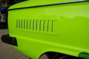 the air intake slots for the air cooling engine of the old classic car are light green. Details of retro cars. close-up and attention to detail. photo