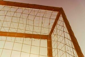 soccer goal on a sandy beach near the sea photo