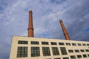 The pipes of the plant and the industrial old factory building photo