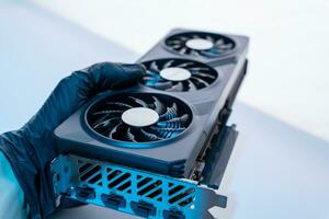 hand of a computer technician holds a modern powerful video game card photo