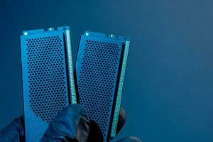 hand of a computer technician holds computer RAM chip. photo