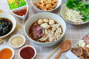 Thai boat noodles with Thai spices and ingredient on background. photo