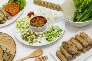 Nam-Neaung. Vietnamese Meatball Wraps,Pork Sausage wraps with vegetables Including tableware photo