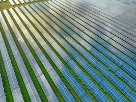 Aerial view of solar farm. Solar power for green energy. Sustainable resources. Solar cell panels use sun light as a source to generate electricity. Photovoltaics or PV. Sustainable renewable energy. photo