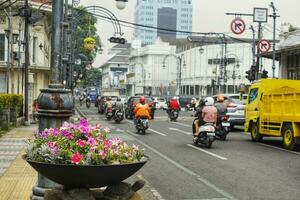 Bandung City, West Java, Indonesia. October 24 2023.  View of Asia Afrika Street in Bandung city. The daily business of city residents. Many vehicles passing by on the road photo