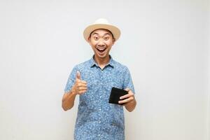 Positive asian man blue shirt wear hat holding wallet amazed show thumb up isolated photo