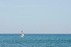 single windsurfer in blue water and blue sky on vacation photo