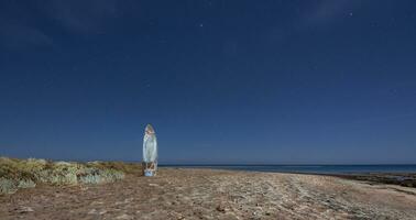 old windsurf board at the sandy beach and blue starry night on vacation in egypt panorama photo