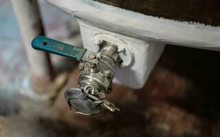 aluminum valve for wine barrels in a wine cellar in the Piedmont Langhe near Alba, in the autumn of 2023 photo