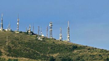 television and telephone antennas and repeaters that deal with telecommunications, on the Ligurian coast of Genoa in the autumn of 2023 photo