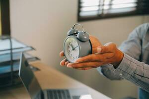 Business working times concept people work typing on laptop computer overlay with in time clock to lunch break photo
